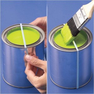 Stop paint splatters with a rubber band or hanger over a paint can